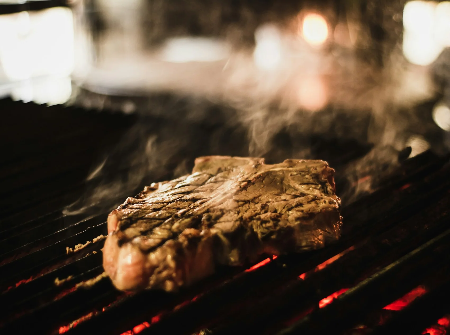 Close view of grilled beef with dark char marks fresh off the heat
