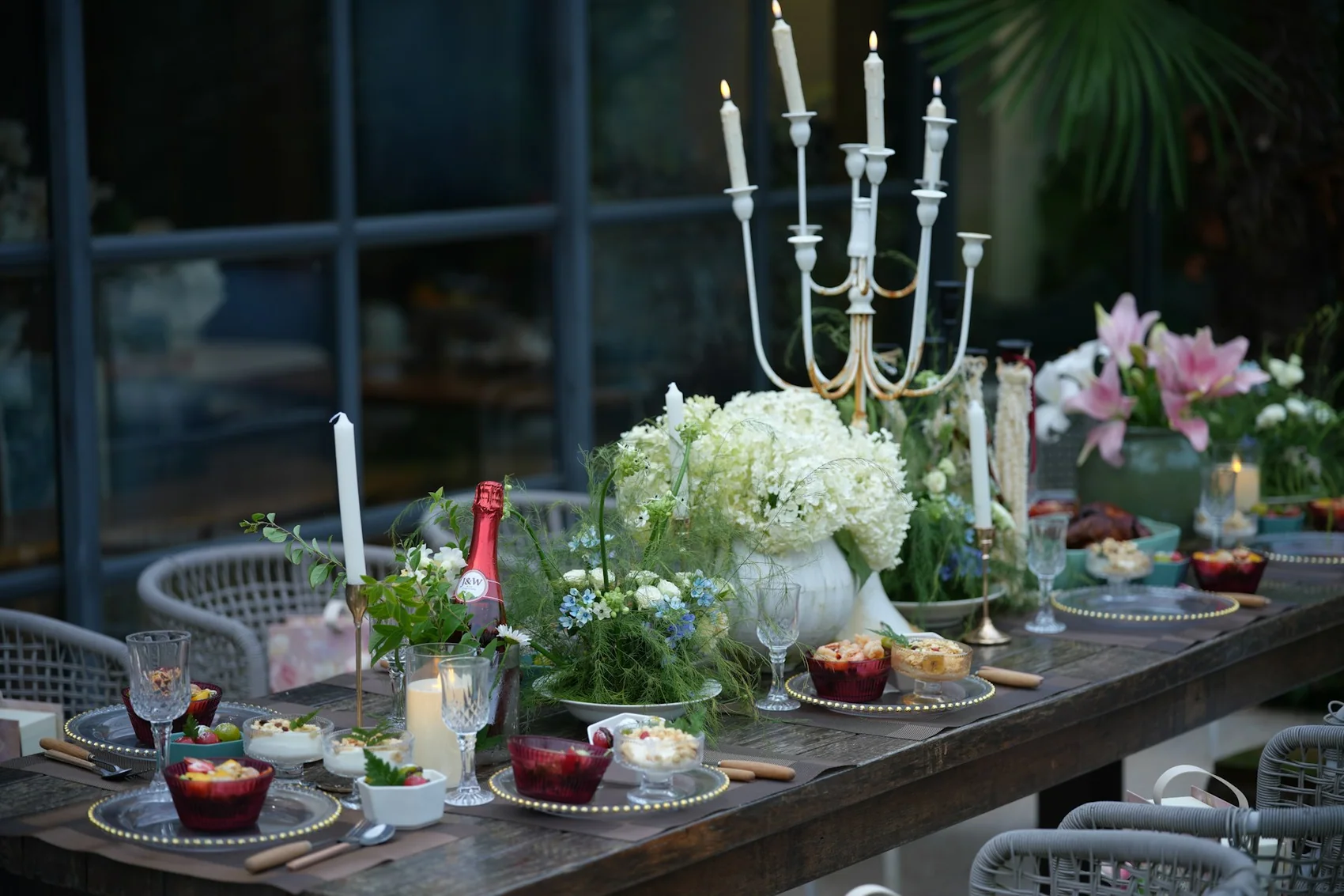A table laid with candles, flowers and glassware before guests arrive